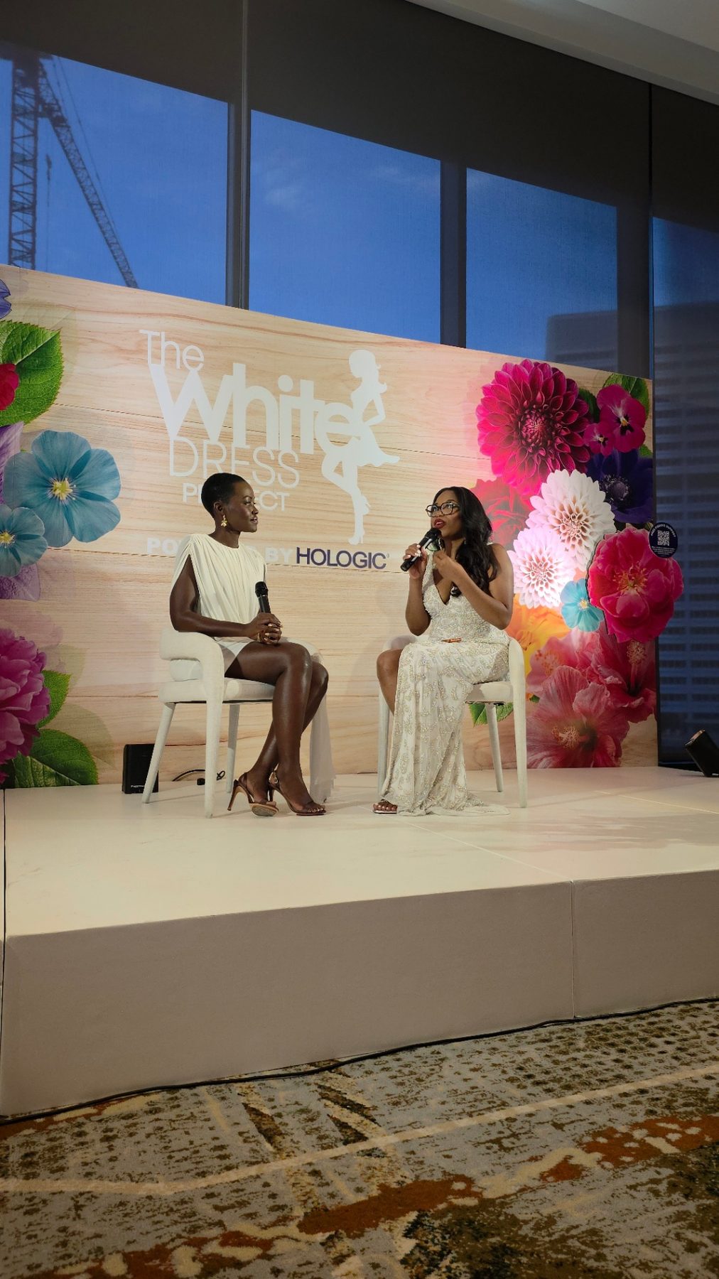 Lupita Amondi Nyong'o on stage with host at The White Dress Project — audiovisual production by ON-POINTAV