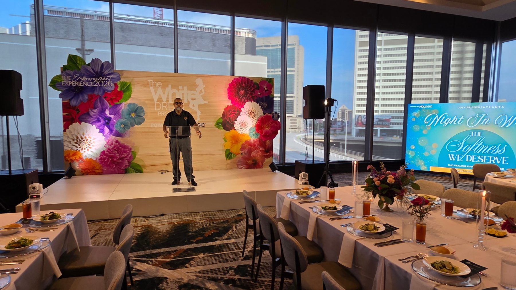 Emcee at podium during Night In White dinner produced by ON-POINTAV in Atlanta