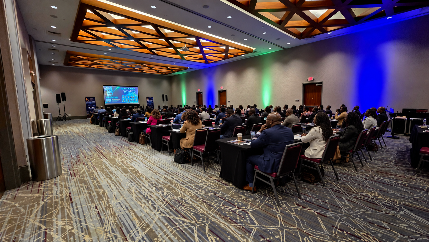 UWE Wealth Unlocked Financial Conference ballroom — projection, stage, and live sound produced by ON-POINTAV in Atlanta